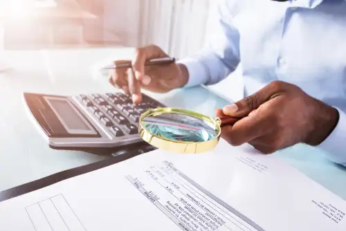 Private Investigator Reviewing Financial Records for Insurance Fraud