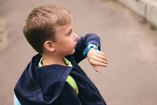 Little Boy Wearing Smart Watch With Child GPS Tracking