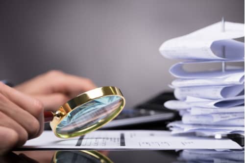 Corporate Investigation investigator examining business documents