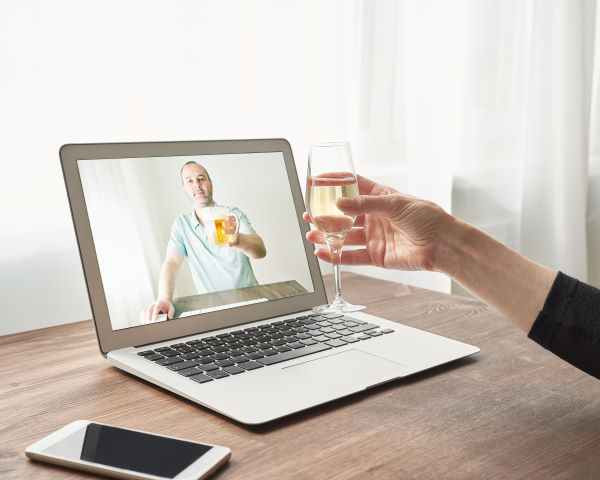 Online romance scam concept: Woman sharing drink with online date